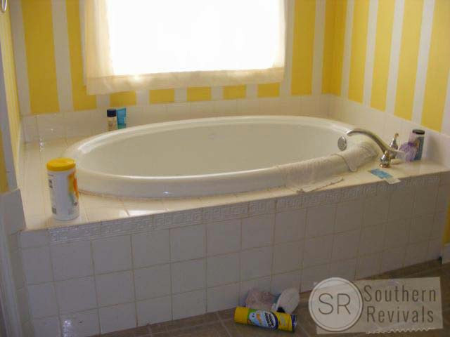 tiled garden tub yellow white stripe wall