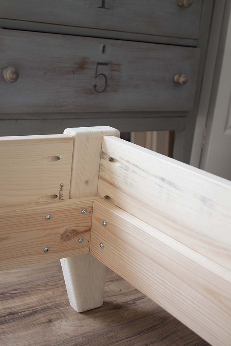 closeup wood bed frame legs 